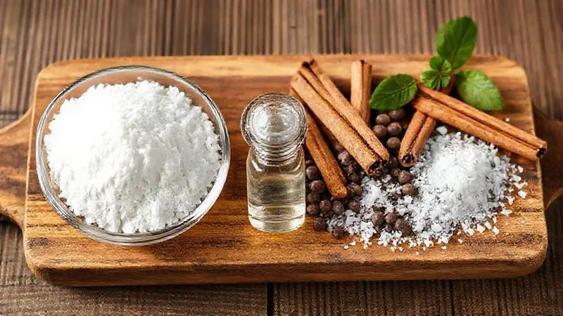 A photorealistic, professional photography shot of various natural sweeteners and flavor enhancers arranged artfully on a wooden board. On one side, bowls of white erythritol, xylitol, and a small vial of clear stevia extract. On the other side, cinnamon sticks, vanilla beans, and a small pile of sea salt flakes. Cinematic lighting, sharp focus on the textures and details, depth of field blurring the background, 8K hyper-detailed, shot on a high-end DSLR.
