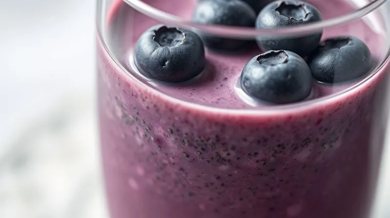 A photorealistic, professional photography shot of a perfectly blended blueberry smoothie in a glass, with a transparent cross-section view revealing tiny fibrous particles and chia seeds suspended within, illustrating the presence of fiber. Cinematic lighting, sharp focus, depth of field. 8K hyper-detailed, professional photography, shot on a high-end DSLR.