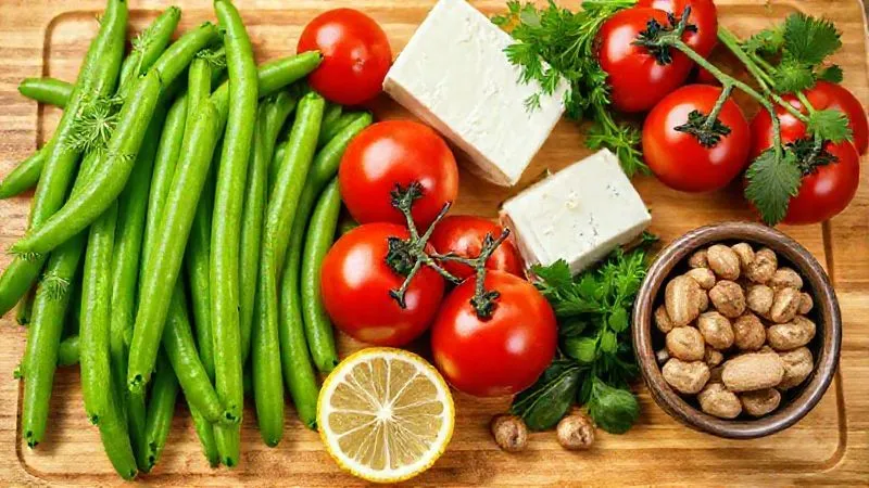 A photorealistic, professional photography shot of a vibrant, colorful array of fresh ingredients laid out on a clean wooden cutting board. Elements include bright green beans, cherry tomatoes, fresh herbs (dill, parsley, basil), a lemon cut in half, a block of feta cheese, and a small bowl of walnuts. Cinematic lighting, sharp focus on the ingredients, depth of field blurring the background, 8K hyper-detailed, shot on a high-end DSLR.