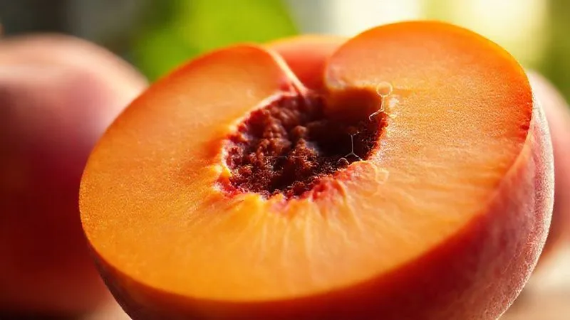 Photorealistic, professional photography, 8K, cinematic lighting, sharp focus, depth of field, shot on a high-end DSLR. A cross-section of a ripe peach showing its fibrous texture and juicy flesh, with a subtle overlay of a scientific diagram illustrating soluble and insoluble fiber molecules. The background is blurred with soft, natural light, emphasizing the health benefits of the fruit.