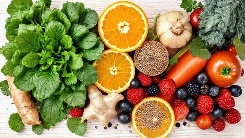 Photorealistic image of a vibrant, colorful assortment of fresh fruits and vegetables specifically chosen for healthy smoothies, including oranges, spinach, kale, ginger, berries, and chia seeds. Arranged artfully on a light wooden background, emphasizing freshness and variety. Professional photography, 8K, cinematic lighting, sharp focus, depth of field.